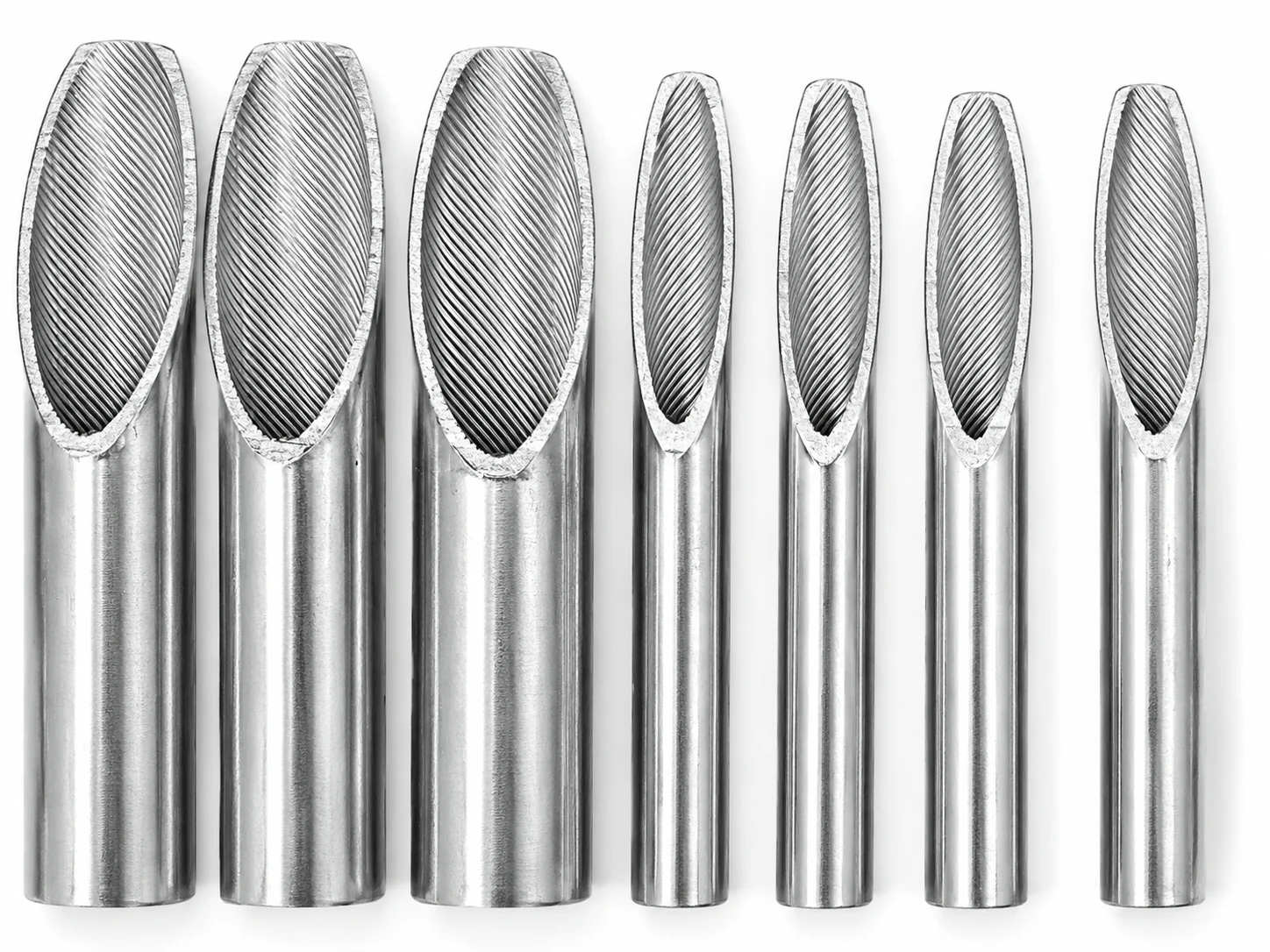 Seven tube samples with angled cut ends exposing spiral grooves on their inner surfaces