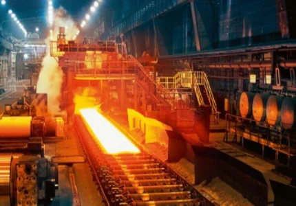 Hot steel moving through industrial metal-processing equipment
