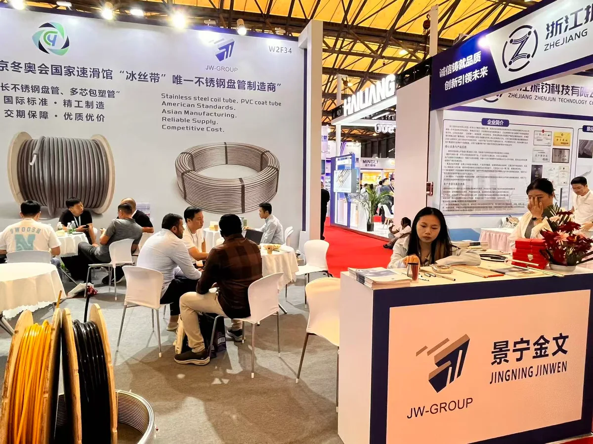 JW-GROUP stand W2F34 with visitors, coil tubing reels and a tubing sample counter at TUBE CHINA 2026
