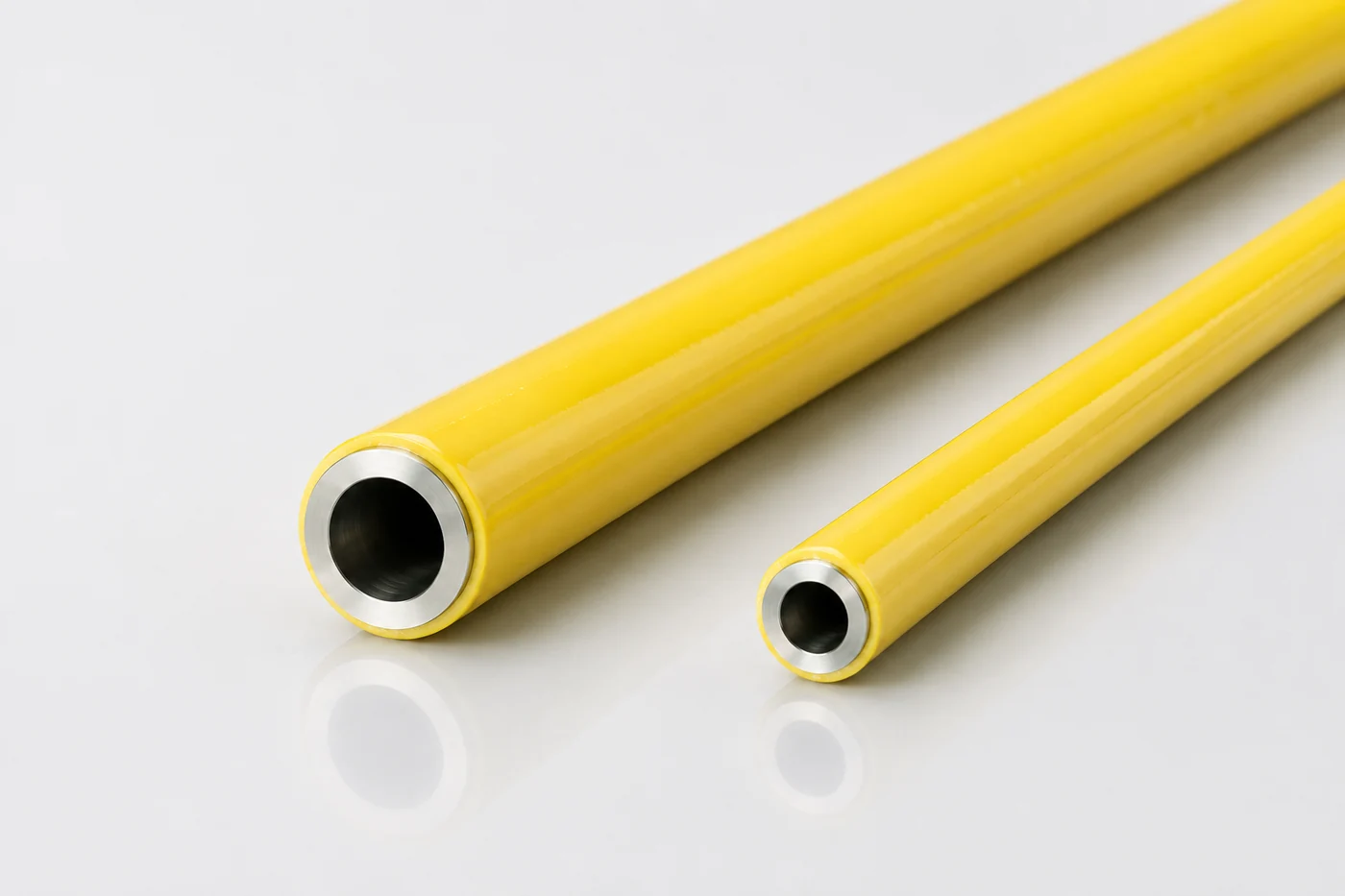 Two yellow-jacketed metal tubes with the inner metal wall visible at their open ends